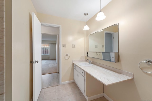 bathroom with vanity, baseboards, and tile patterned floors