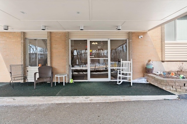 entrance to property with brick siding