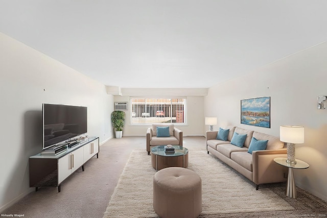 living area featuring light carpet, a wall mounted air conditioner, and baseboards