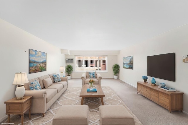 living room featuring baseboards, a wall mounted air conditioner, and light colored carpet