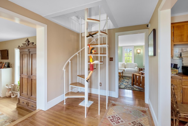 stairway with baseboards and wood finished floors