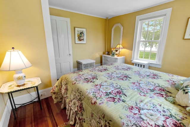 bedroom featuring baseboards and wood finished floors