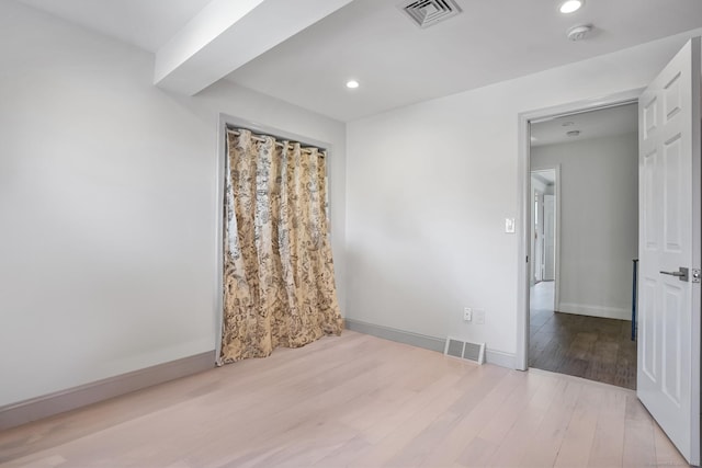 spare room featuring visible vents, wood finished floors, and recessed lighting