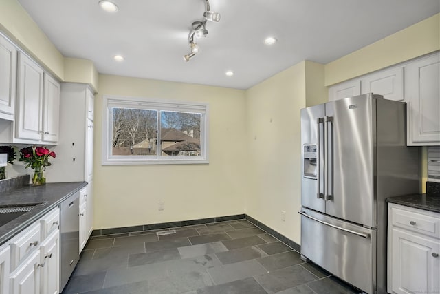 kitchen featuring baseboards, appliances with stainless steel finishes, white cabinets, and recessed lighting