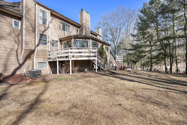 rear view of house with stairs, a chimney, cooling unit, and a wooden deck