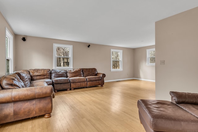 living room with light wood finished floors and baseboards