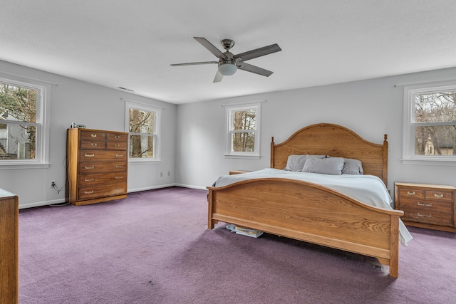 bedroom featuring multiple windows, carpet, a ceiling fan, and baseboards