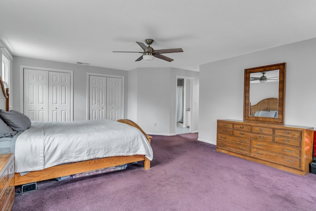 bedroom featuring two closets, visible vents, a ceiling fan, carpet flooring, and baseboards