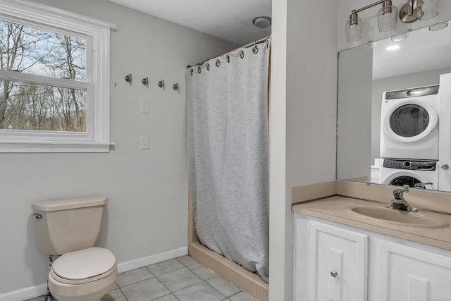 bathroom with curtained shower, tile patterned flooring, toilet, baseboards, and stacked washer and clothes dryer