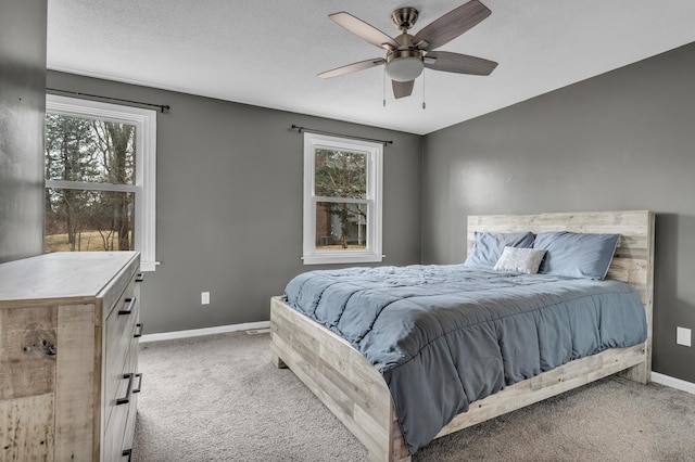 bedroom with carpet flooring, baseboards, and multiple windows