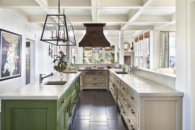 kitchen featuring a sink, light countertops, coffered ceiling, and green cabinetry