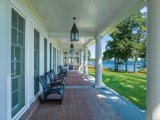 view of patio / terrace featuring a water view and a porch