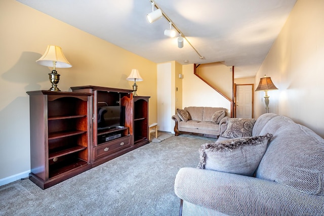 carpeted living area with rail lighting