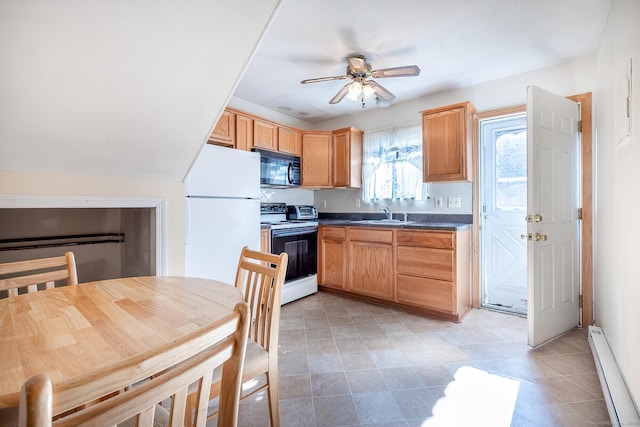 kitchen with black microwave, a baseboard radiator, electric stove, freestanding refrigerator, and dark countertops