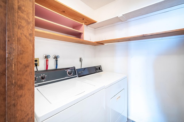 clothes washing area featuring laundry area and separate washer and dryer