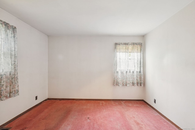 carpeted empty room with baseboards