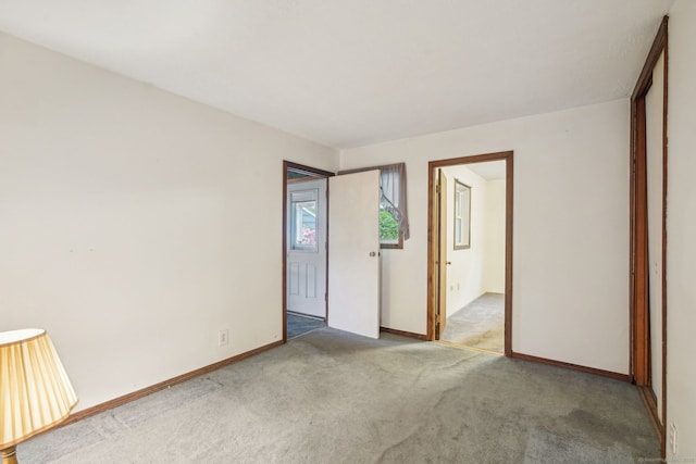 unfurnished bedroom with carpet flooring and baseboards