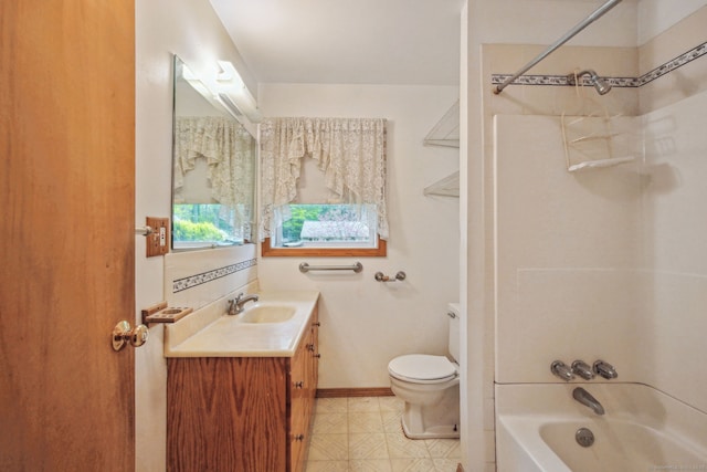 bathroom featuring toilet, baseboards, vanity, and shower / washtub combination