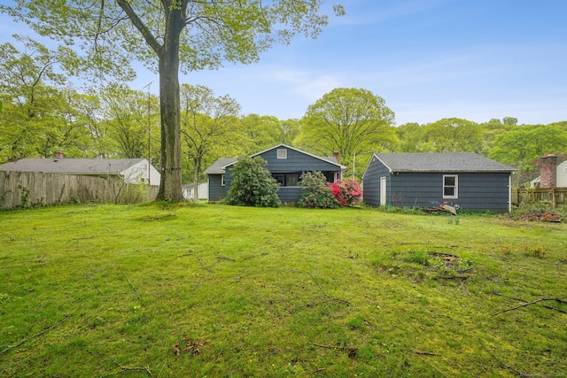 view of yard featuring fence and an outdoor structure