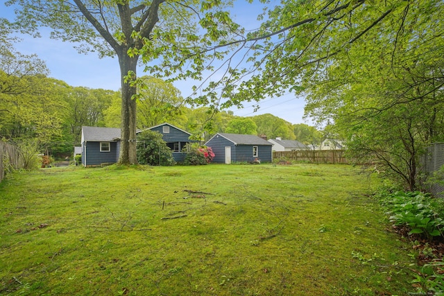 view of yard with a fenced backyard and an outdoor structure