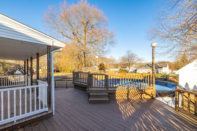 wooden deck featuring a fenced in pool