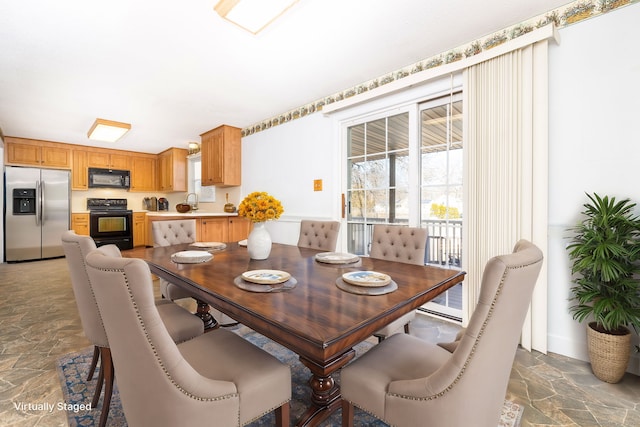 dining room featuring stone tile floors