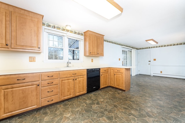 kitchen featuring light countertops, black dishwasher, baseboard heating, a peninsula, and stone finish floor