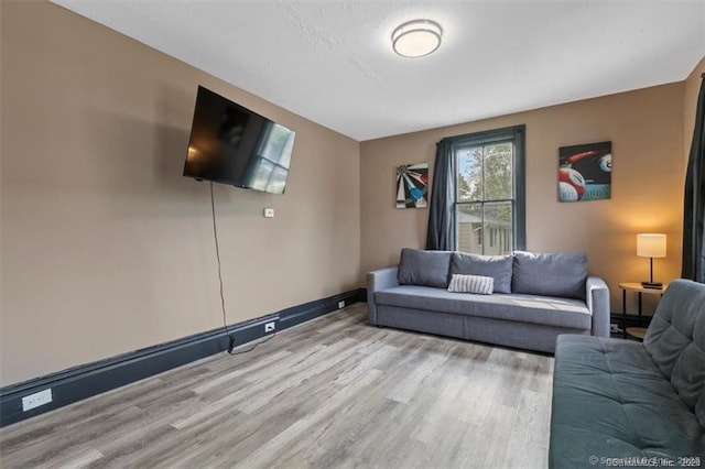 living room with wood finished floors and baseboards