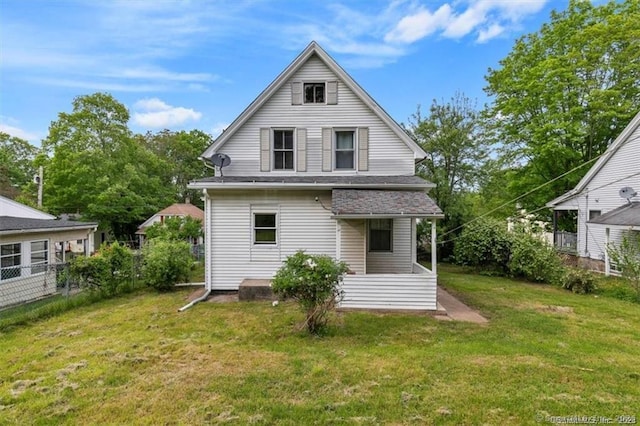 back of house with a yard and fence