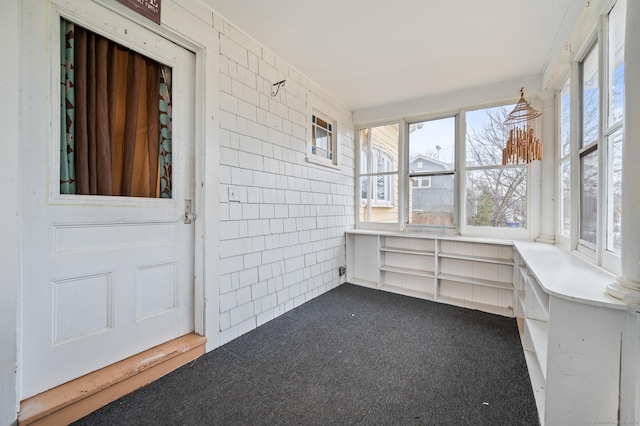 unfurnished sunroom featuring carpet flooring