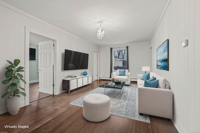 living room featuring a chandelier, crown molding, wood finished floors, and a baseboard radiator
