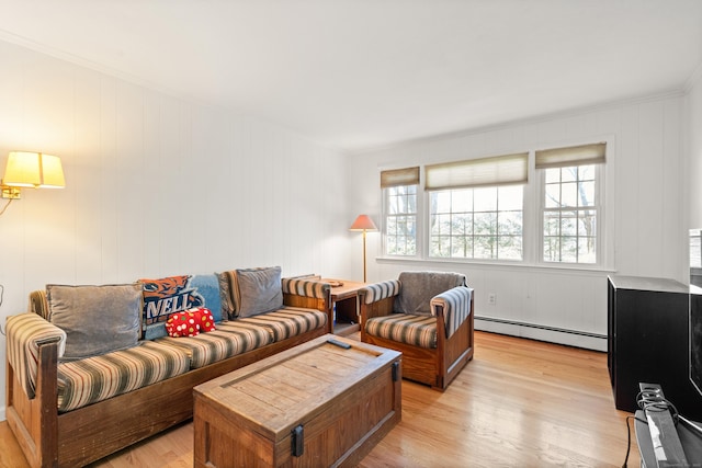 living area with crown molding, light wood-type flooring, and a baseboard radiator