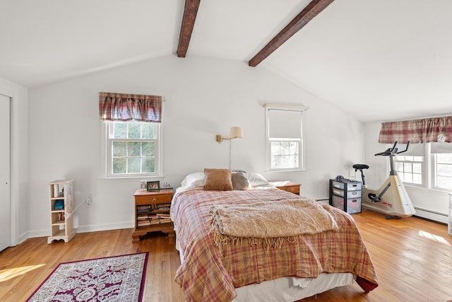 bedroom with lofted ceiling with beams, multiple windows, wood finished floors, and baseboards