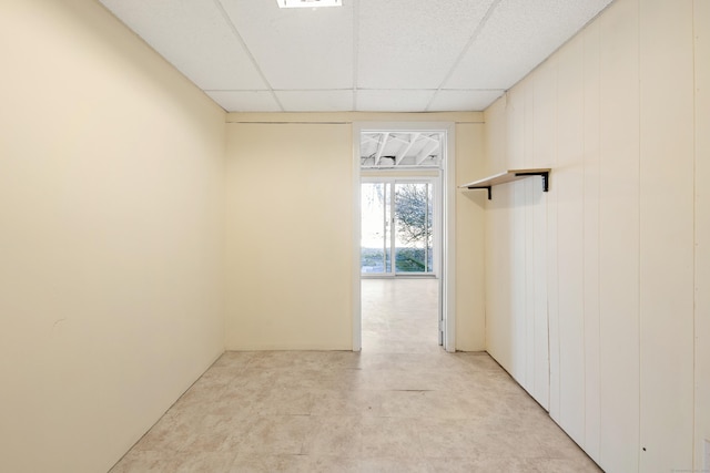 unfurnished room featuring a drop ceiling