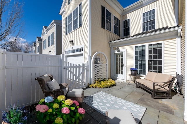 exterior space with fence, an attached garage, and a gate