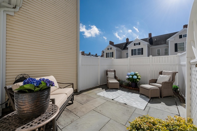 view of patio featuring a fenced backyard and a residential view