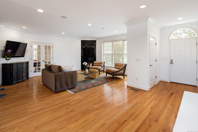 interior space featuring visible vents, recessed lighting, french doors, crown molding, and light wood finished floors