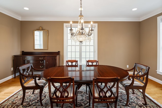 dining area featuring light wood-type flooring, baseboards, and a chandelier