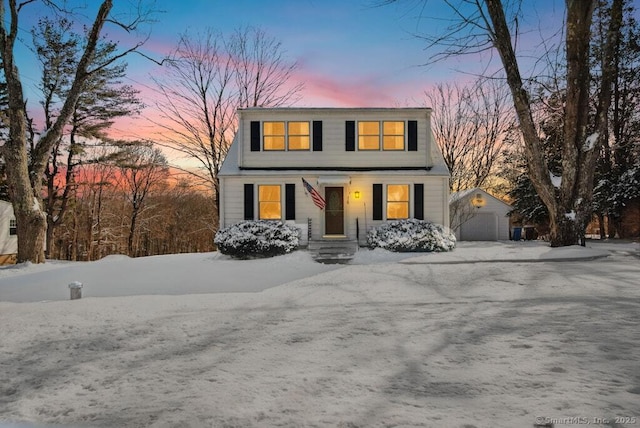 dutch colonial featuring a detached garage and an outdoor structure