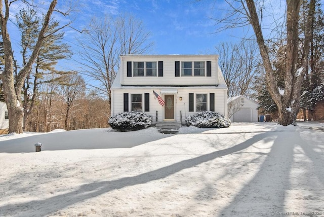 view of front of home featuring a garage and an outbuilding