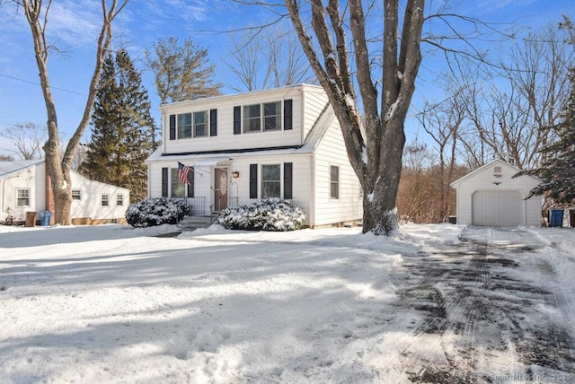 view of front of property with a detached garage and an outbuilding