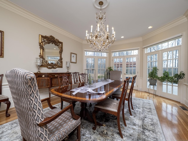 dining space with crown molding, recessed lighting, visible vents, and light wood-style floors