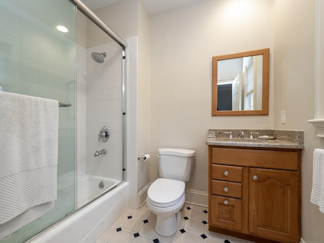 full bath featuring baseboards, toilet, enclosed tub / shower combo, tile patterned flooring, and vanity