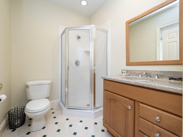 bathroom featuring baseboards, a shower stall, toilet, and vanity