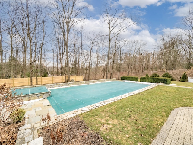 view of pool featuring a yard, fence, and a fenced in pool