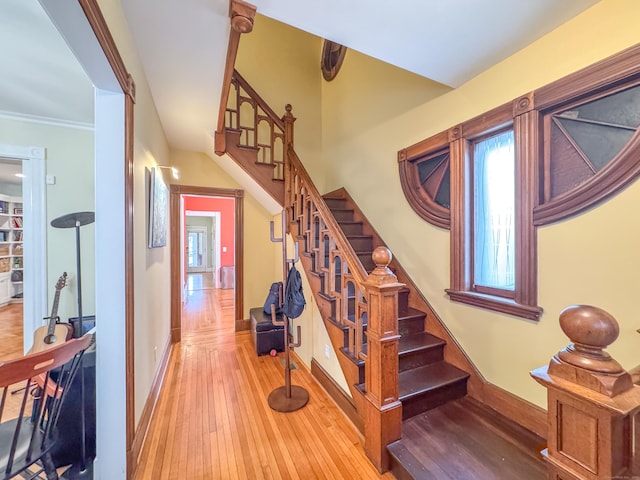 stairs featuring wood-type flooring and baseboards