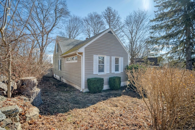 view of side of property with a shingled roof