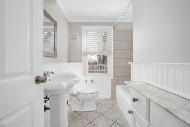 bathroom with tile patterned floors, a wainscoted wall, visible vents, toilet, and crown molding