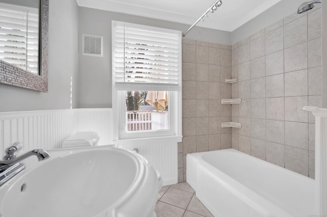 bathroom with tile patterned flooring, a wainscoted wall, visible vents, and a sink