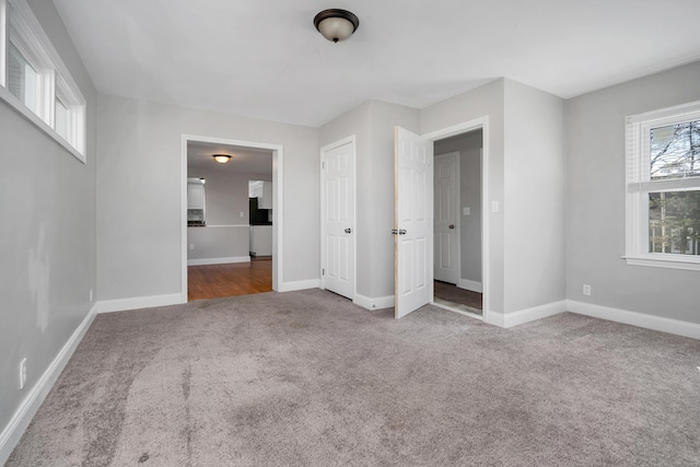 unfurnished bedroom featuring carpet flooring and baseboards